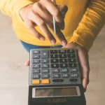 person-holding-calculator
