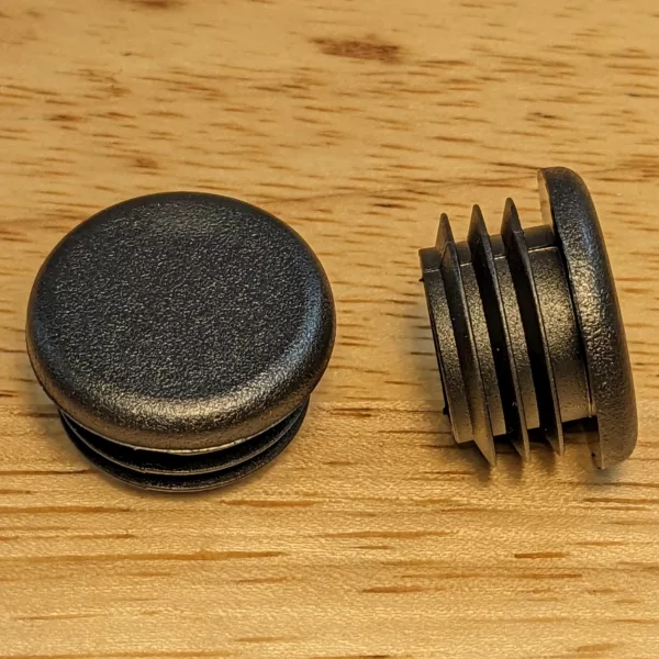 A pair of black plastic end caps