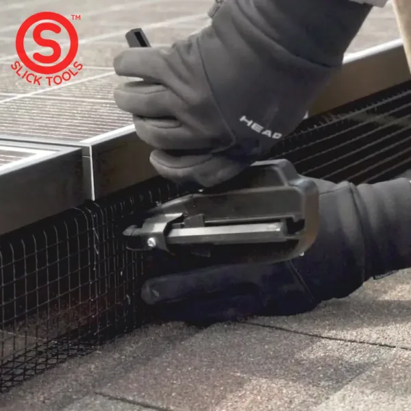A hog ring gun being used to attach two pieces of wire mesh together underneath solar panels